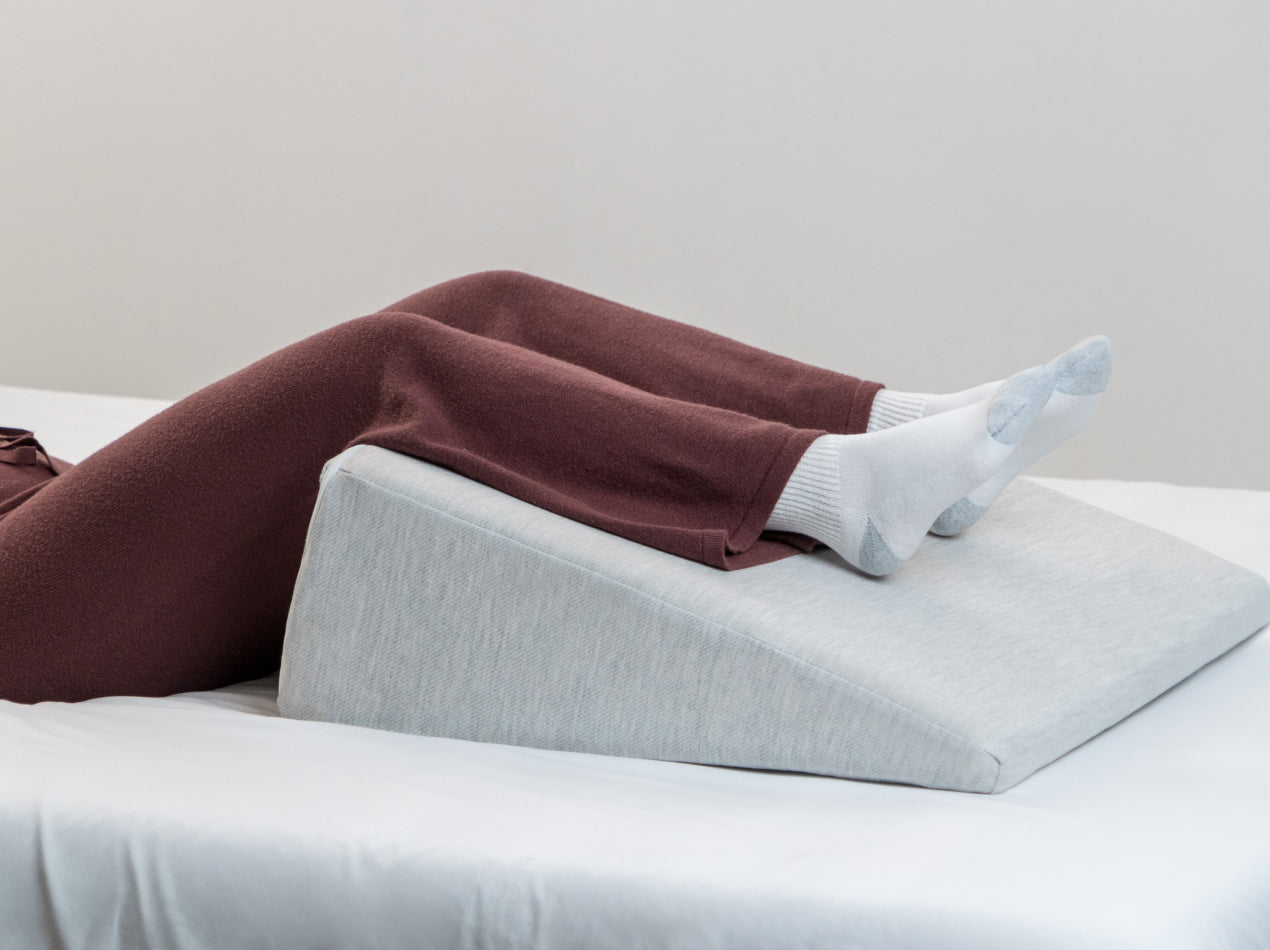 Wedge pillow lifestyle used for leg elevation 