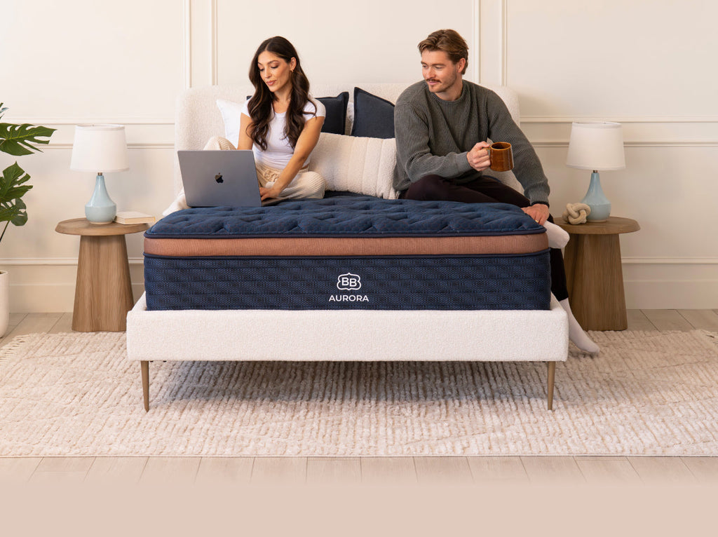 Couple sitting on Brooklyn Bedding Aurora mattress
