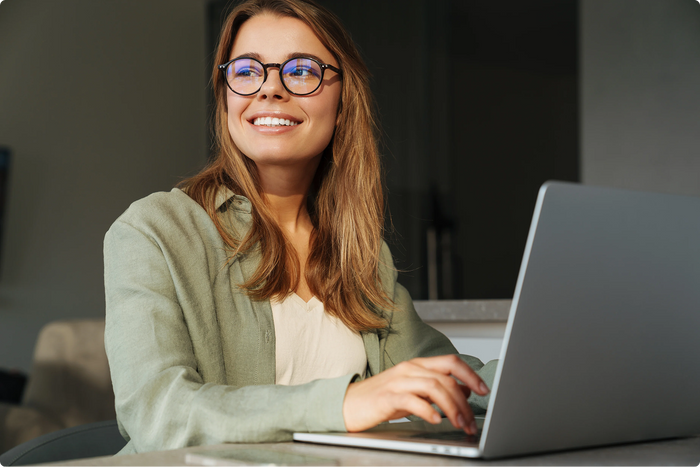 Woman with glasses using a laptop