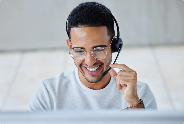Man wearing a headset and smiling