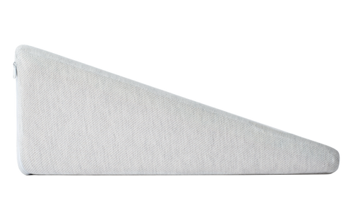 Beige wedge pillow on a bed with a wooden headboard